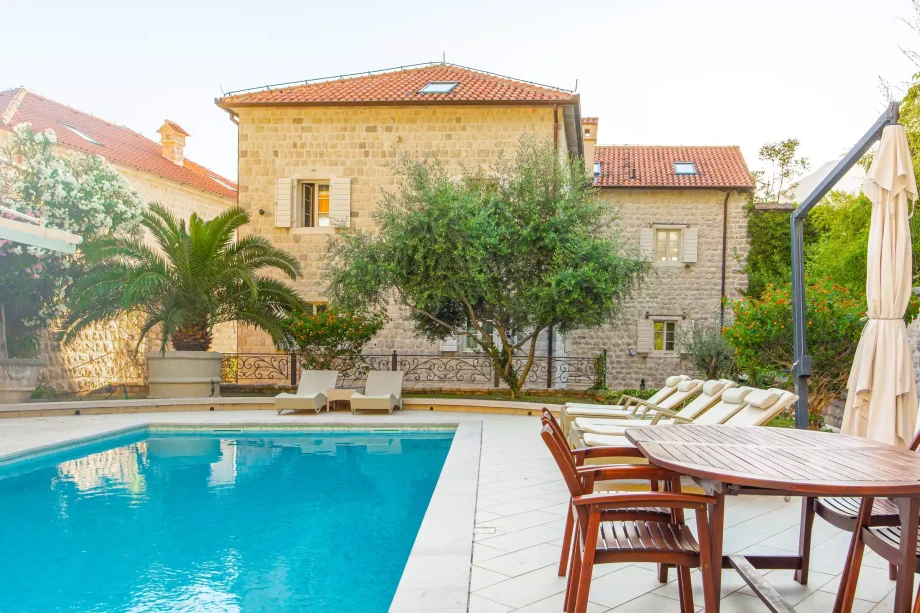 Relaxing in the Lush Garden of Stone House Seafront Villa