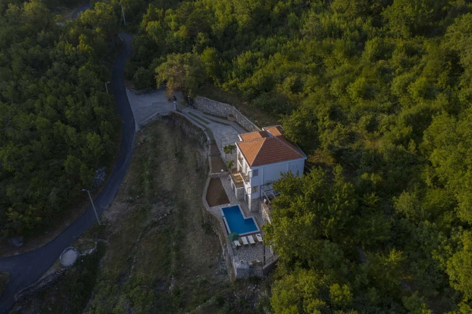 Elegant Mediterranean-style villa exterior with lush garden