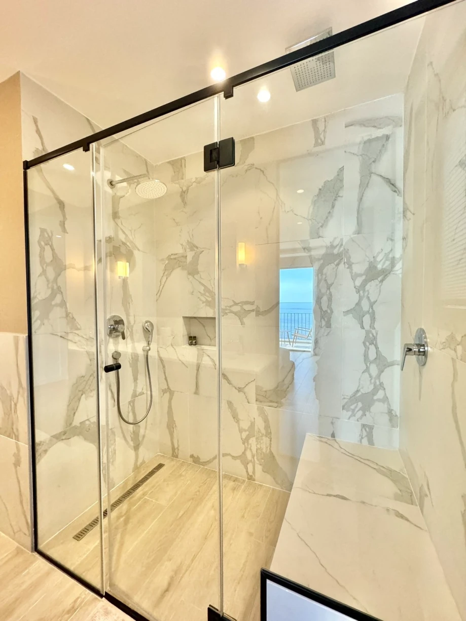Modern Bathroom Featuring a Large Shower Cabin and Chic Tile Accents at Villa Solis