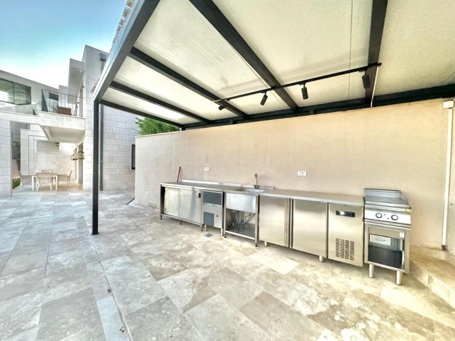 Spacious Outdoor Area with Relaxing Seating and Poolside View at Villa Solis
