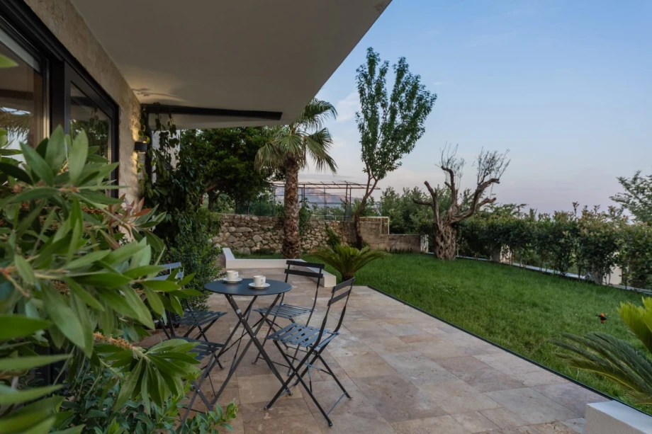 Spacious yard with outdoor seating and greenery at a Montenegro villa