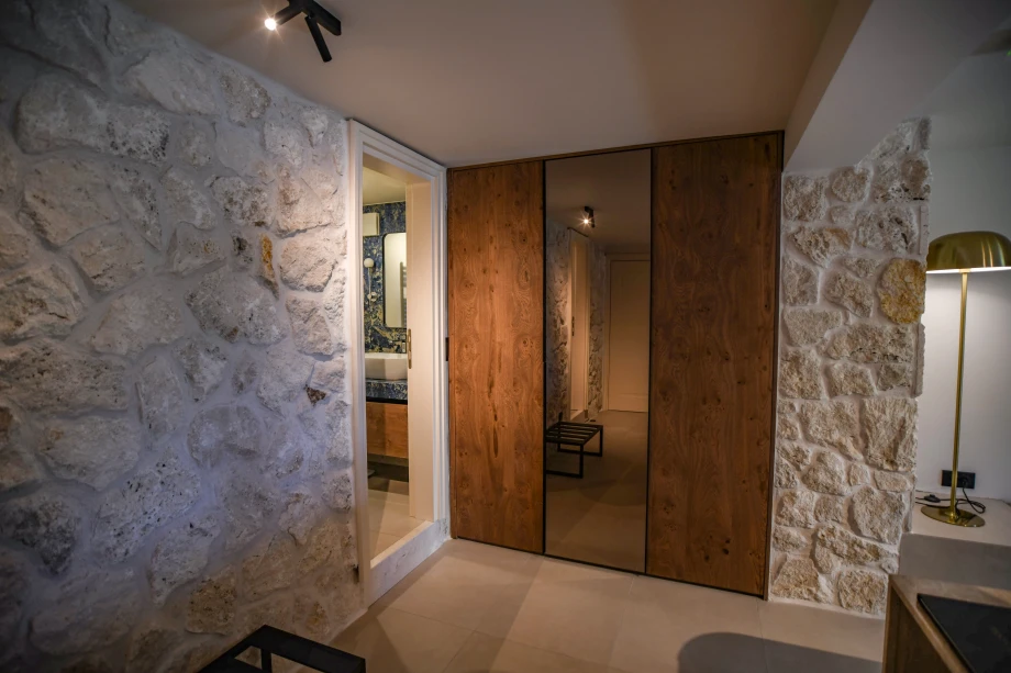 Spacious Walk-In Closet with Custom Shelving and Ambient Lighting