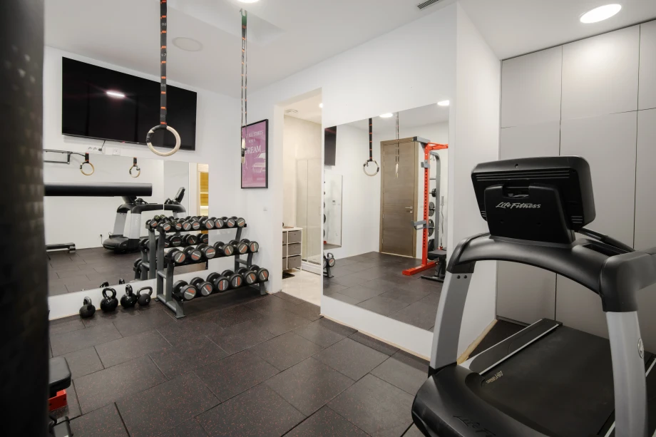 Spacious villa gym with modern workout equipment