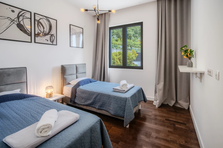 Villa bedroom with single bed and minimalist décor