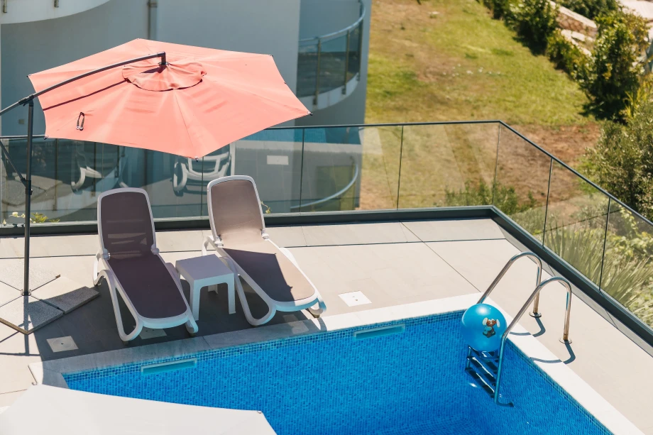 Relax by the private pool on comfortable sunbeds