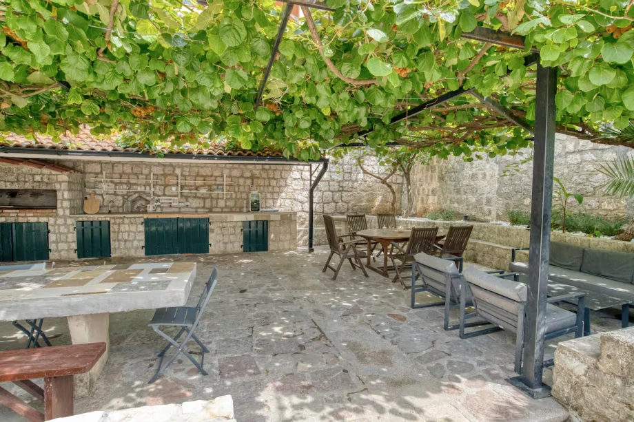Outdoor Stone Dining and Barbecue Area with Vines