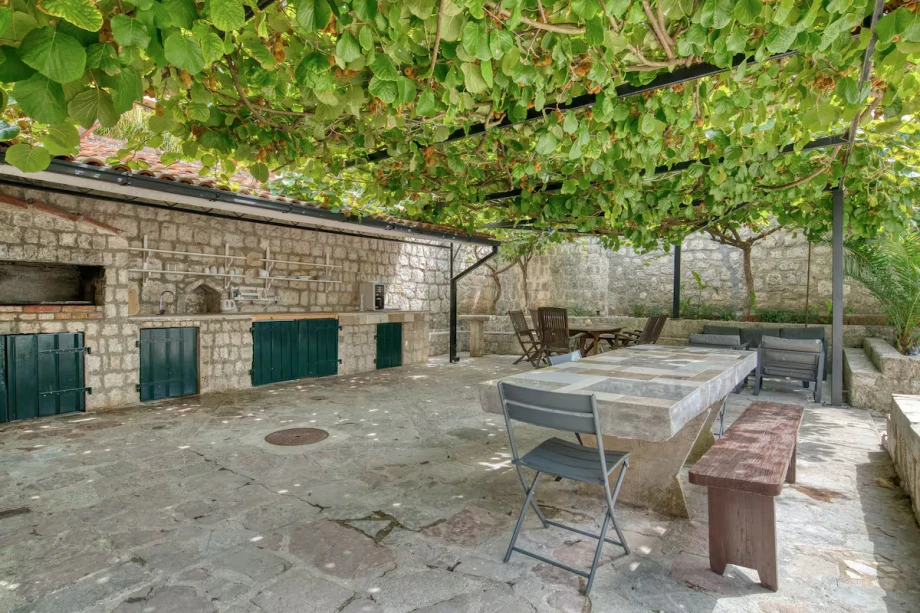 Outdoor Stone Dining Area with Grill