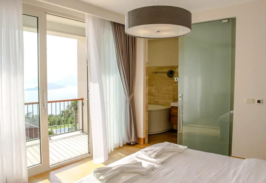 Seaside Bedroom with Sliding Glass Doors and Balcony View