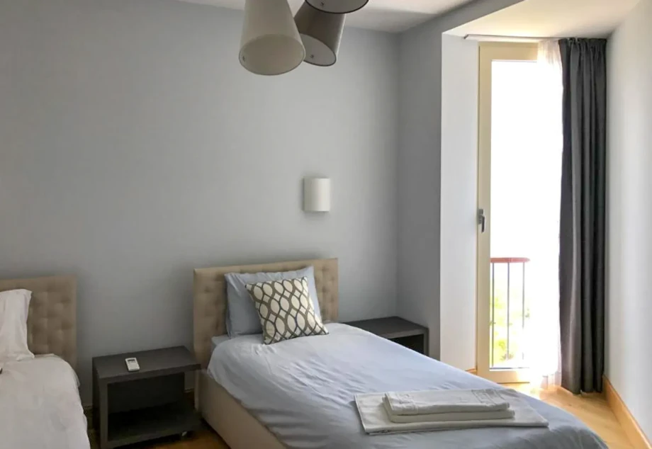 Charming Twin Bedroom with Coastal Light and Neutral Decor