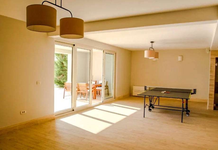 Indoor Table Tennis Setup with Sliding Glass Doors and Games Area at Villa