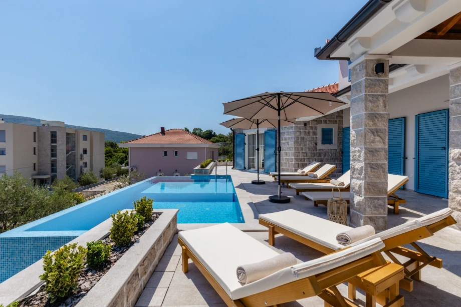 Outdoor Pool Area with Loungers and Sea Breeze