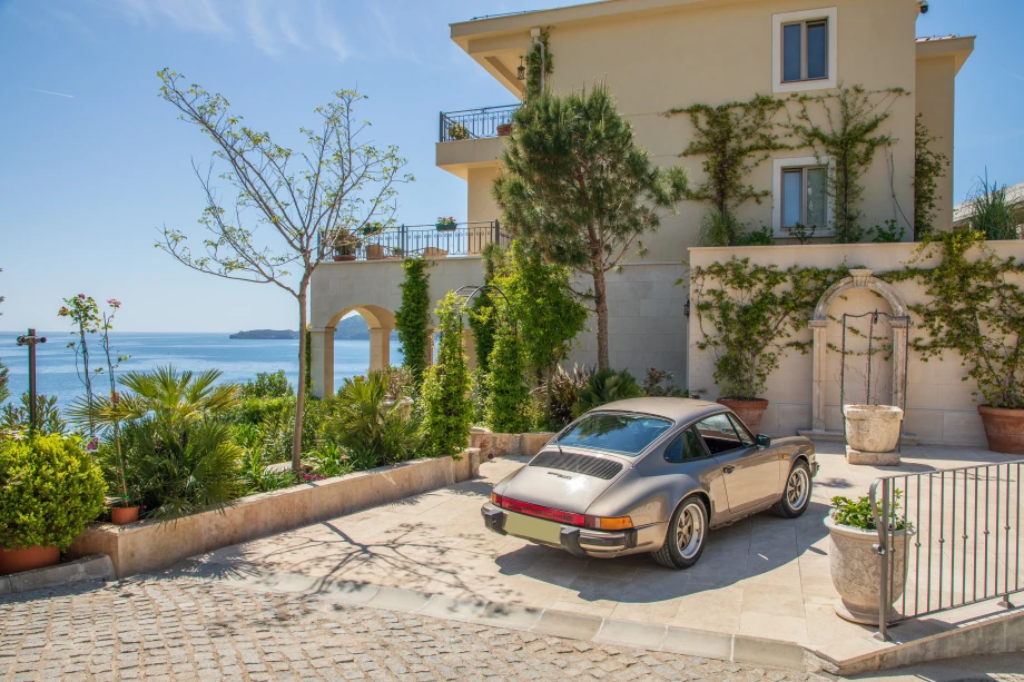 Elegant entrance of Villa Cliffside Royal Estate with modern stone facade
