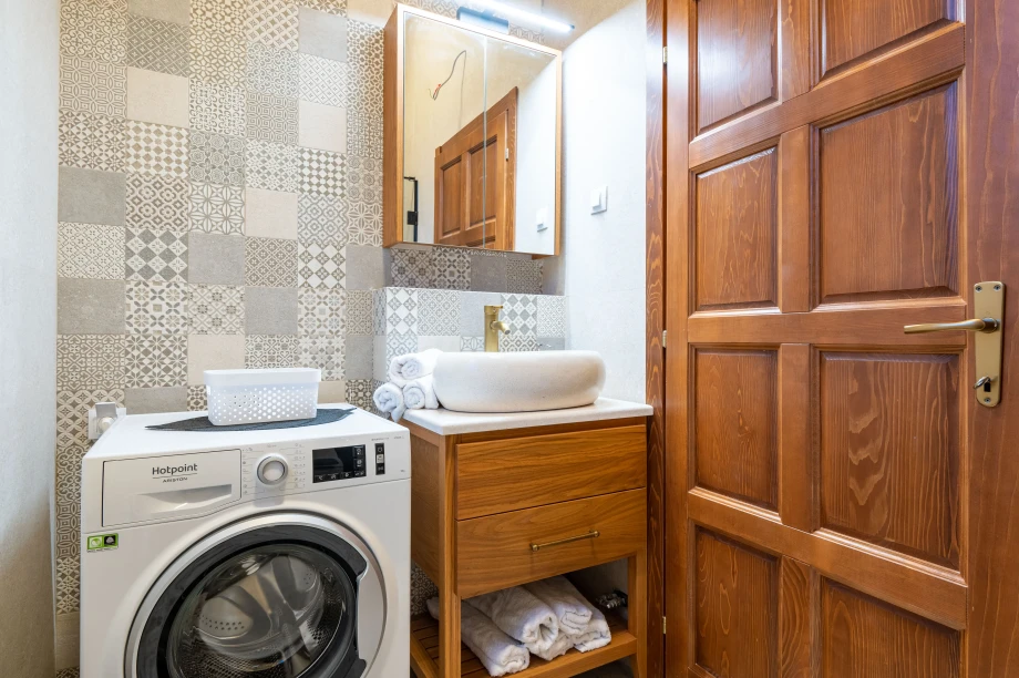 Well-Equipped Bathroom with Washing Machine at Villa Calista Cove