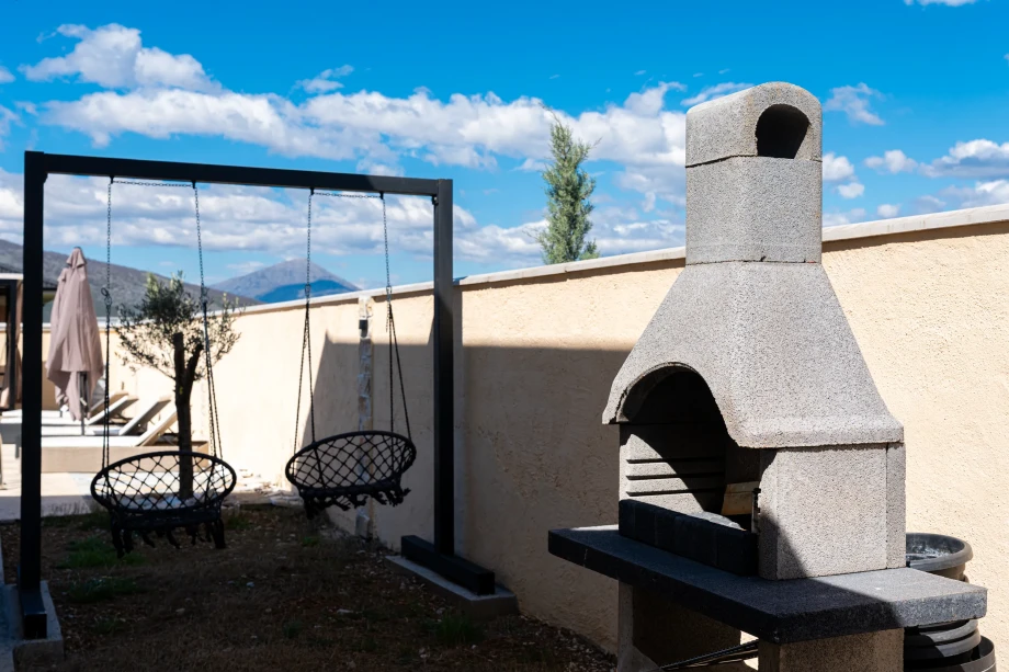 Relaxing Area Near Barbecue at Villa Armonia with Outdoor Gathering Space