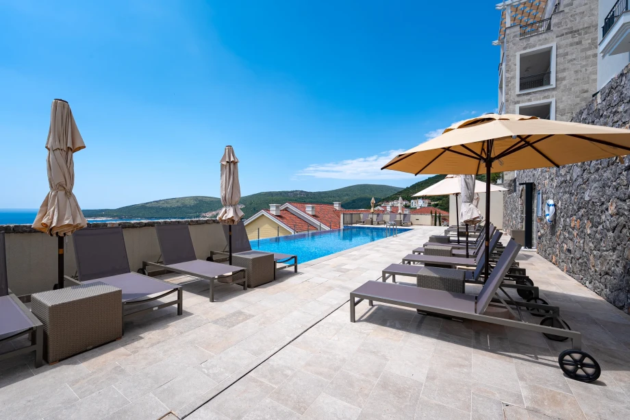 Relaxing Poolside Loungers at Coastal Elegance Residences