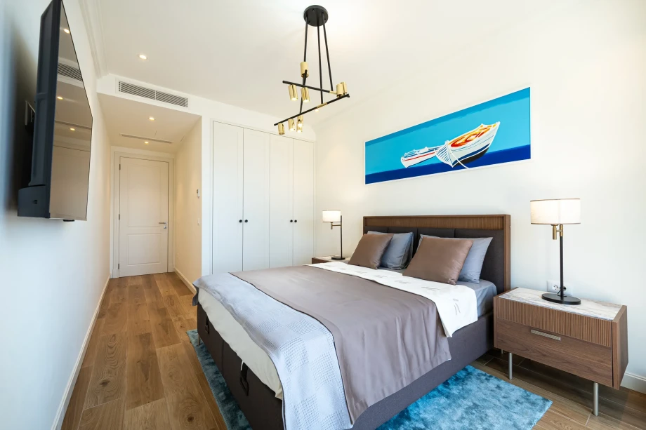 King Bed and Entertainment Area at Coastal Elegance Residence