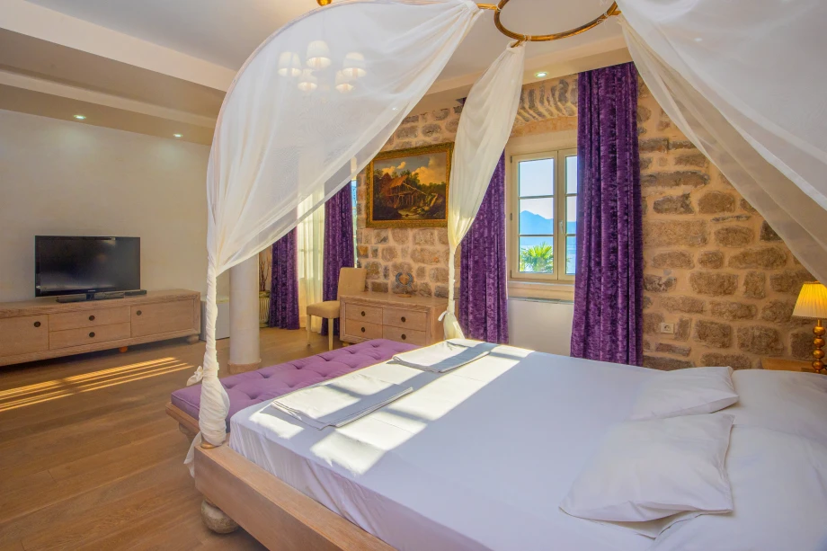 Neatly Made King Bed in Large Bedroom | Stone House Seafront Villa
