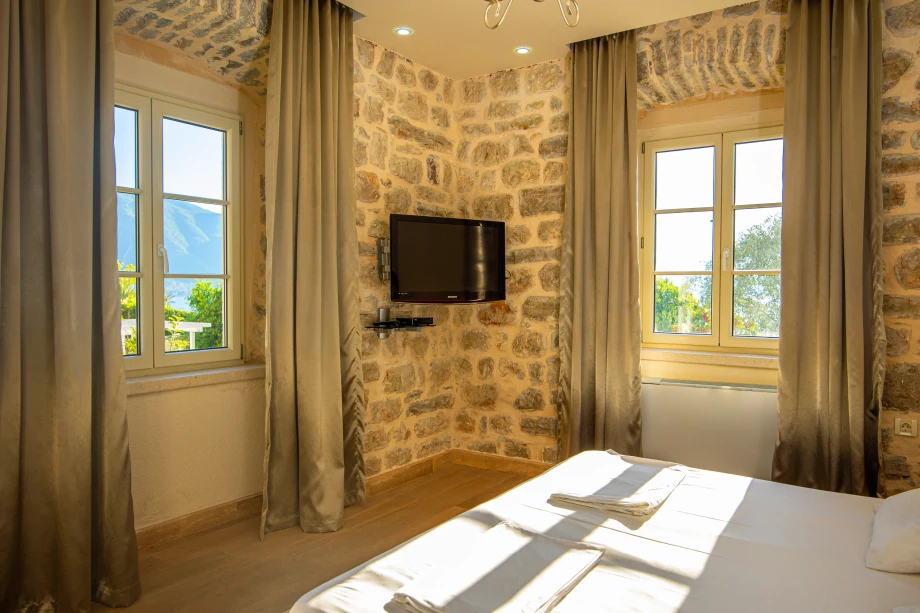 Elegant Bedroom with TV | Stone House Seafront Villa