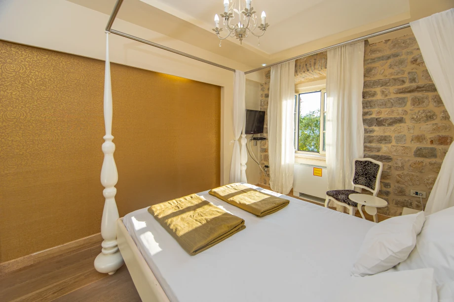 Neatly Made Bed with TV | Stone House Seafront Villa